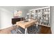 Bright office space with custom built-in bookshelves, modern desk, and stylish decor at 4294 Silver Peak Pkwy, Suwanee, GA 30024