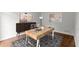 A stylish home office featuring a wooden desk, modern decor, and hardwood flooring at 4294 Silver Peak Pkwy, Suwanee, GA 30024