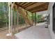 Covered patio with wooden stairs leading to backyard and fenced perimeter at 4294 Silver Peak Pkwy, Suwanee, GA 30024