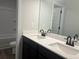 Bathroom with dual sinks, dark cabinets, large mirror, and a shower/tub combination at 4514 Eastbrook Pl, Snellville, GA 30039