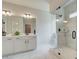 Elegant bathroom featuring a double vanity, marble floors, and a glass-enclosed walk-in shower at 4514 Eastbrook Pl, Snellville, GA 30039