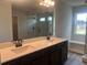 Bathroom with dual sinks, dark cabinets, and glass enclosed shower with tiled walls at 4514 Eastbrook Pl, Snellville, GA 30039