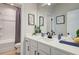 Bathroom with a modern vanity and framed mirror, complemented by a tub-shower combo at 4514 Eastbrook Pl, Snellville, GA 30039