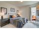 Well-lit bedroom featuring a comfortable bed with a stylish throw blanket and bedside lamps at 4514 Eastbrook Pl, Snellville, GA 30039