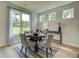 Inviting dining area with a round table, upholstered chairs, and bright natural light from large windows at 4514 Eastbrook Pl, Snellville, GA 30039