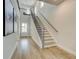 Bright foyer showcasing wood floors, staircase with wrought iron railings, and ample natural light at 4514 Eastbrook Pl, Snellville, GA 30039