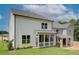 View of the home's exterior, featuring a screened porch and lush green lawn, perfect for outdoor entertaining at 4514 Eastbrook Pl, Snellville, GA 30039