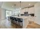 Stylish kitchen with a center island, pendant lights, and bar stool seating with views of the breakfast nook at 4514 Eastbrook Pl, Snellville, GA 30039