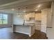 Modern kitchen features granite countertops, white cabinets, stainless steel appliances, and an island with pendant lighting at 4514 Eastbrook Pl, Snellville, GA 30039
