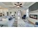 Open-concept living room featuring a fireplace, coffered ceiling, and seamless flow to the kitchen at 4514 Eastbrook Pl, Snellville, GA 30039