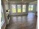 Open-concept living area with electric fireplace, hardwood floors, and windows showcasing a well-maintained yard at 4514 Eastbrook Pl, Snellville, GA 30039
