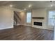 Spacious living room with a modern fireplace, recessed lighting, and sleek hardwood floors at 4514 Eastbrook Pl, Snellville, GA 30039