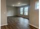 Open living space featuring hardwood floors, recessed lighting, and a large window showcasing the neighborhood view at 4514 Eastbrook Pl, Snellville, GA 30039