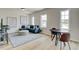 Inviting living room with large windows, comfortable seating, and modern decor, complemented by wood flooring at 4514 Eastbrook Pl, Snellville, GA 30039