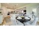 Open-concept living space with a kitchen island, dining table, and a cozy living room at 4514 Eastbrook Pl, Snellville, GA 30039