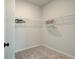 A walk-in closet with white wire shelving and a carpeted floor provides efficient storage space at 4514 Eastbrook Pl, Snellville, GA 30039