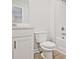 Clean white bathroom featuring a modern vanity, toilet, and a combined shower and bathtub at 4651 Larkfield Way, Powder Springs, GA 30127