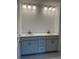 Bathroom vanity with dual sinks, gray cabinetry, and modern globe lighting above at 4651 Larkfield Way, Powder Springs, GA 30127