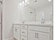 Bathroom features dual sinks with white cabinets and a large well-lit mirror at 4651 Larkfield Way, Powder Springs, GA 30127