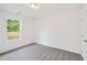 Comfortable bedroom featuring carpeted floors, white walls, and a window offering a peaceful view at 4651 Larkfield Way, Powder Springs, GA 30127