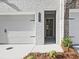 Close up of the front door and garage featuring painted brick and a convenient two car garage at 4651 Larkfield Way, Powder Springs, GA 30127