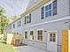 Gray siding townhome exterior featuring a wooden fence and an outside A/C unit at 4651 Larkfield Way, Powder Springs, GA 30127