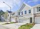 View of new townhomes with attached garages, painted brick, and professionally landscaped front yards at 4651 Larkfield Way, Powder Springs, GA 30127