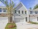 Stylish townhome showcases a two-car garage, gray brick exterior, and well-maintained lawn at 4651 Larkfield Way, Powder Springs, GA 30127