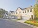 Exterior view of townhomes boasting gabled roofs, garages, and manicured lawns at 4651 Larkfield Way, Powder Springs, GA 30127