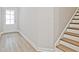 Foyer featuring wood-look flooring, stairs with a white banister, and a front door at 4651 Larkfield Way, Powder Springs, GA 30127