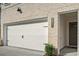 Attached two car garage with a white door, address numbers, and a brick facade on a sunny day at 4651 Larkfield Way, Powder Springs, GA 30127