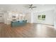 Open concept kitchen and living area featuring a large island, stainless steel appliances, and hardwood floors at 4651 Larkfield Way, Powder Springs, GA 30127