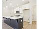 Bright kitchen features stainless steel appliances, white cabinets, and a kitchen island with seating at 4651 Larkfield Way, Powder Springs, GA 30127