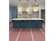 A kitchen island with a white countertop and blue base is featured beneath three pendant lights at 4651 Larkfield Way, Powder Springs, GA 30127