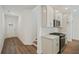 Modern kitchen features stainless steel appliances, white cabinets, and wood-look flooring at 4651 Larkfield Way, Powder Springs, GA 30127