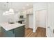 Well-lit kitchen featuring a spacious island with a sink, stainless steel appliances, and sleek countertops at 4651 Larkfield Way, Powder Springs, GA 30127