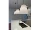 Close up on modern kitchen island featuring stainless steel sink, faucet, white countertop and stylish lighting at 4651 Larkfield Way, Powder Springs, GA 30127
