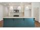Modern kitchen boasts a large island with seating, stainless steel appliances, and stylish pendant lighting at 4651 Larkfield Way, Powder Springs, GA 30127
