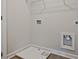 Bright laundry room featuring utility connections and a white drain pan, ready for appliances at 4651 Larkfield Way, Powder Springs, GA 30127