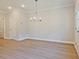 Open-concept living area with modern chandelier and plenty of natural light at 4651 Larkfield Way, Powder Springs, GA 30127