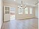 Spacious living room with backyard access, plenty of windows, and modern lighting at 4651 Larkfield Way, Powder Springs, GA 30127