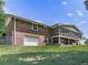 Back exterior with a garage, screened porch and a brick facade at 760 Oakdale Rd, Canton, GA 30114