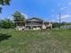 Back exterior view featuring a screened porch, patio, and a lush green yard, perfect for entertaining at 760 Oakdale Rd, Canton, GA 30114