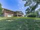 Back exterior with a brick facade, a large screened porch, and a well-maintained lawn at 760 Oakdale Rd, Canton, GA 30114