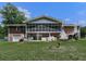 Spacious backyard featuring a screened in porch, open patio area, and stairs leading to the second level at 760 Oakdale Rd, Canton, GA 30114