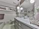 Well-lit bathroom features a marble countertop, decorative pieces, and ample lighting at 760 Oakdale Rd, Canton, GA 30114