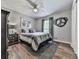 Comfortable bedroom with a ceiling fan, decorative artwork, and a cozy striped comforter at 760 Oakdale Rd, Canton, GA 30114