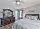 Relaxing bedroom boasts a ceiling fan, a large dresser, and a comfortable bed at 760 Oakdale Rd, Canton, GA 30114