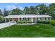 Charming brick home with manicured front lawn and mature landscaping, well maintained at 760 Oakdale Rd, Canton, GA 30114