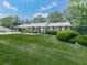 Charming single-story home with well-manicured lawn and mature landscaping in a lush setting at 760 Oakdale Rd, Canton, GA 30114